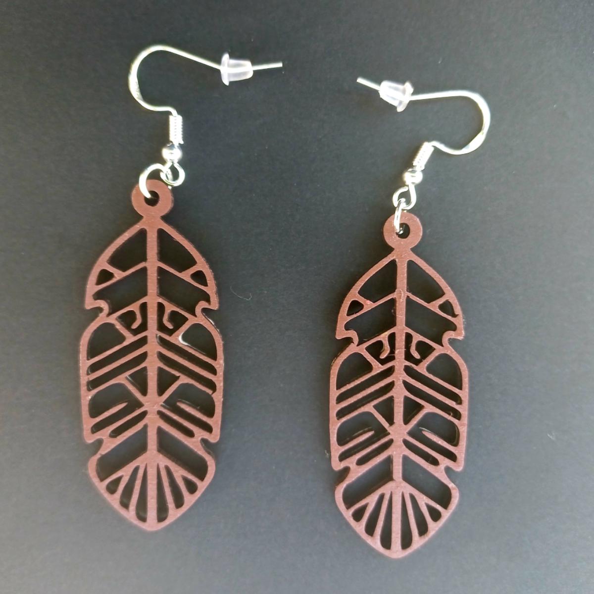 Boucles d'oreilles pendantes en bois ajouré en forme de plume de couleur marron avec crochets argentés hypoallergéniques