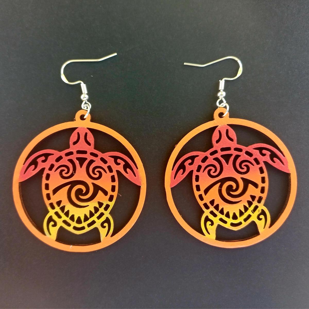 Boucles d'oreilles pendantes rondes en bois ajouré avec motif de tortue maorie en dégradé rouge, orange et jaune