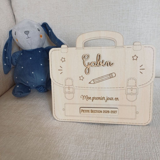 Pancarte en bois brut découpée en forme de cartable d'école avec prénoms Gabin et Olivia personnalisés en relief pour photo souvenir de rentrée scolaire